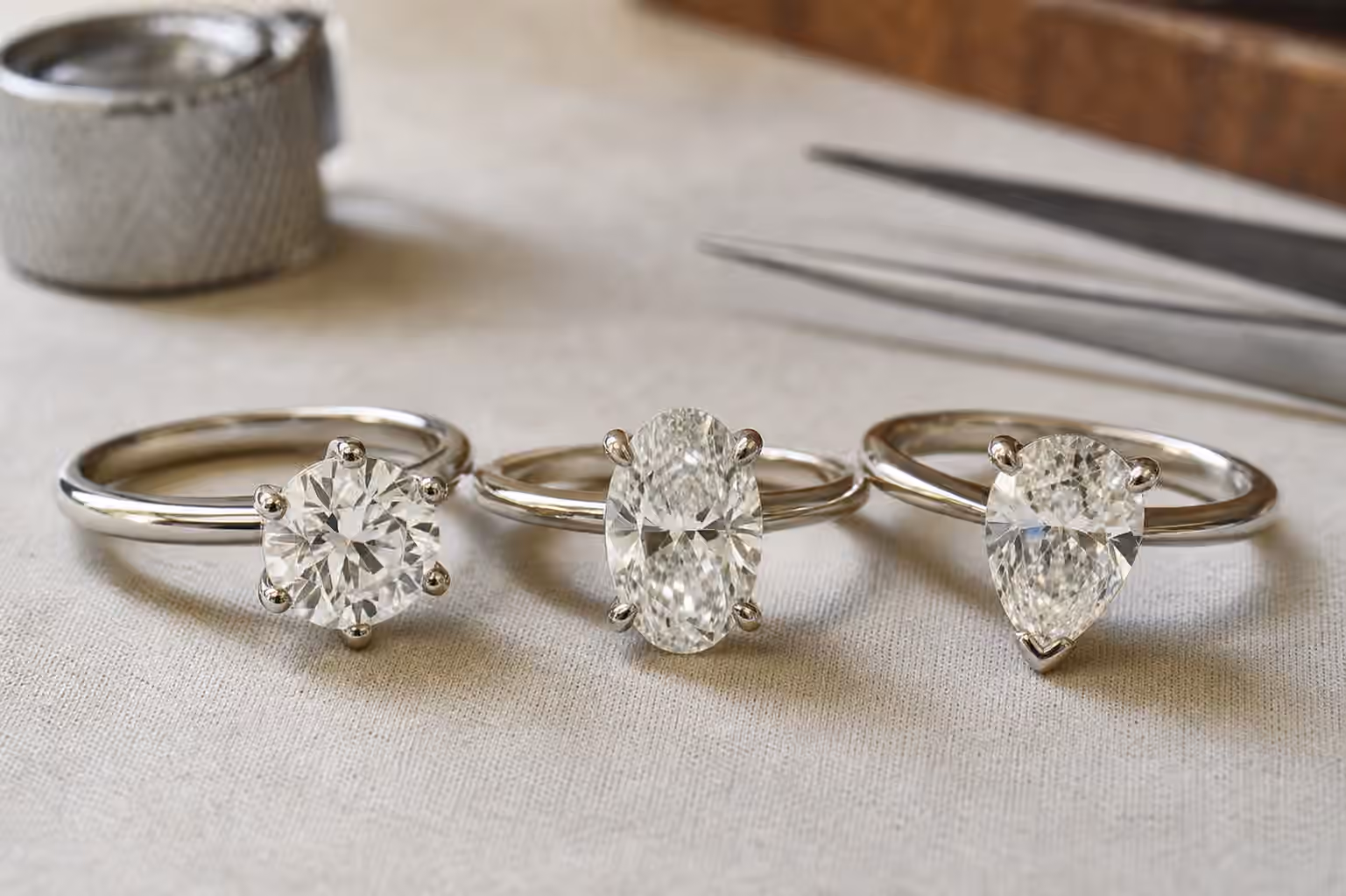 Three engagement ring heads showing rounded prongs, claw prongs, and a protective V-prong.