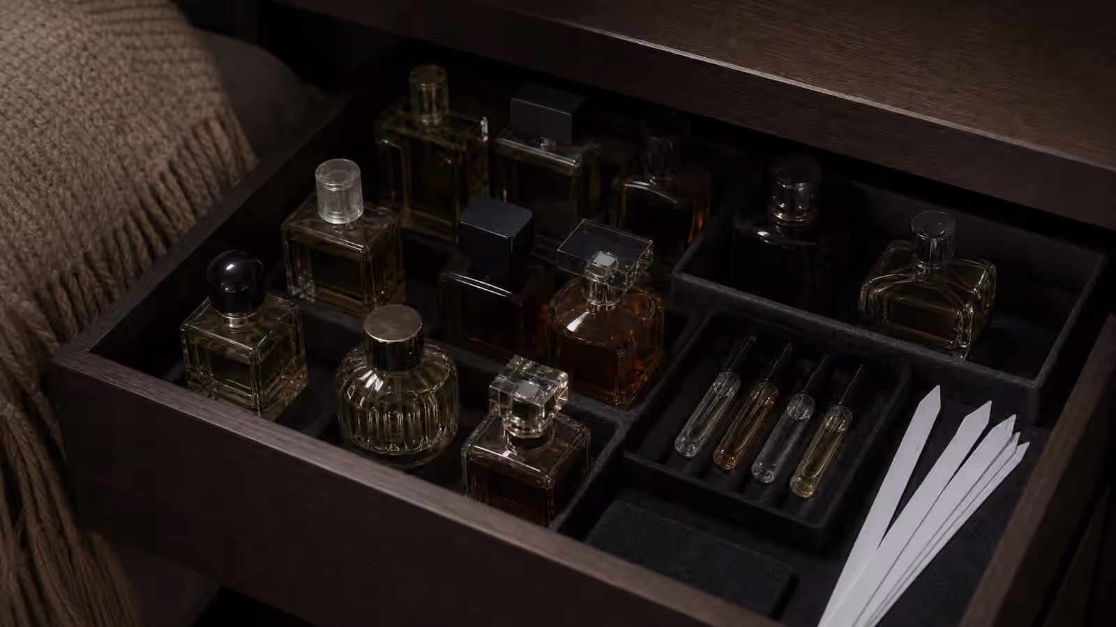 Perfume bottles stored in a shaded drawer away from light and heat