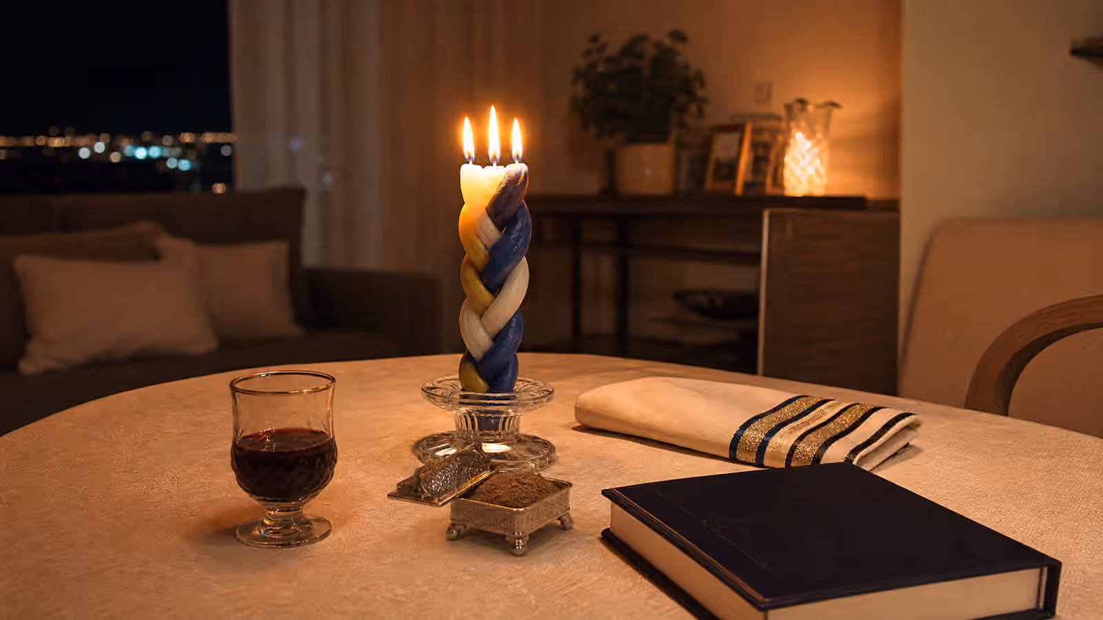 Havdalah table with braided candle, cup, spice box, and folded cloth