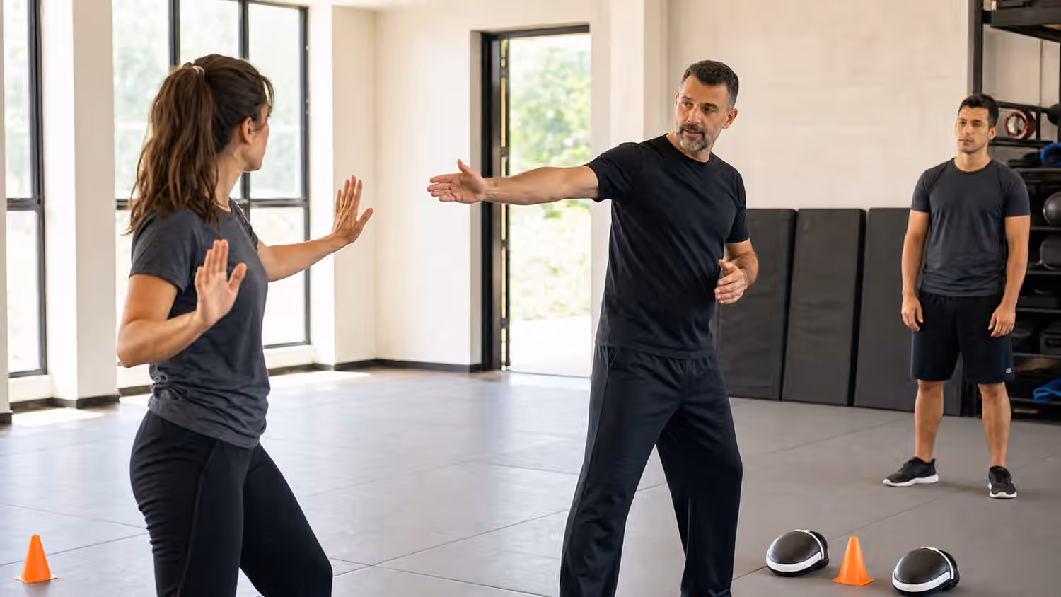 A Krav Maga instructor guides a student through a calm reset after a startle drill.