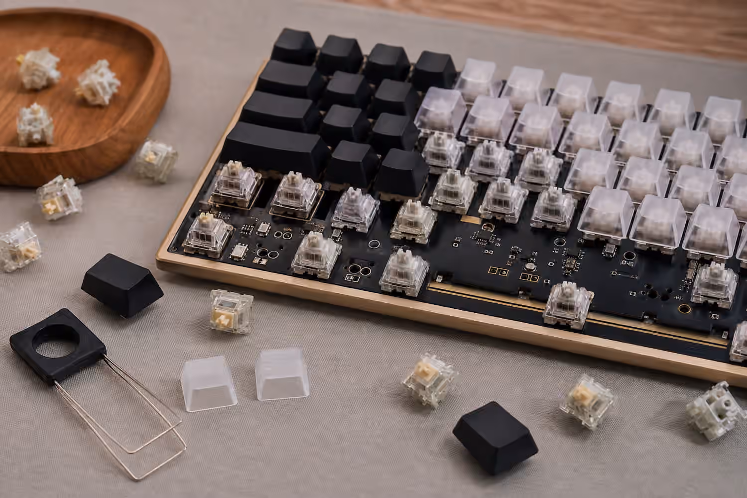 Partly disassembled hot-swap keyboard showing switches, PCB, and blank keycaps.